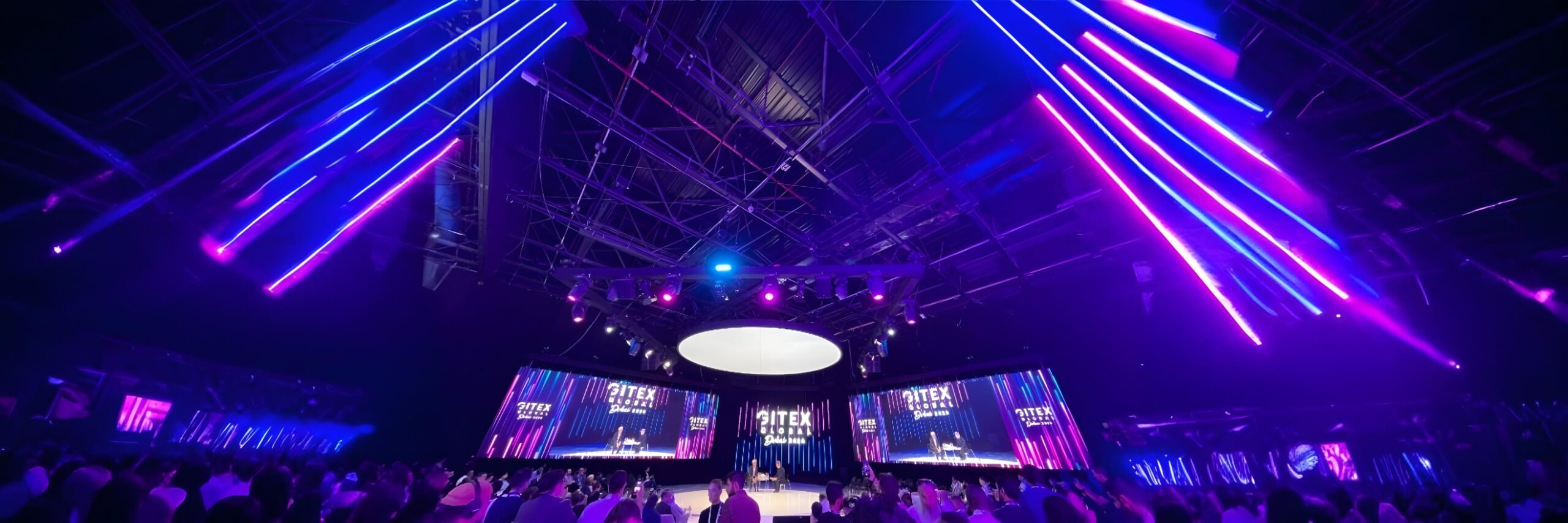 A view of the stage and screens at Gitex Global 2024, where speakers are presenting to an audience eager to learn about the latest in technology